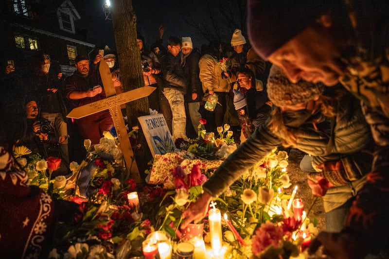 Mourners light candles at a makeshift memorial for Renee Nicole Good, near the site where she was shot in Minneapolis. Photograph: David Guttenfelder/The New York Times
                      
