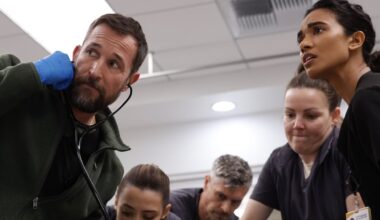 A team of doctors crowd around an operating table