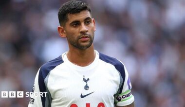 Cristian Romero wearing a white Tottenham matchday shirt