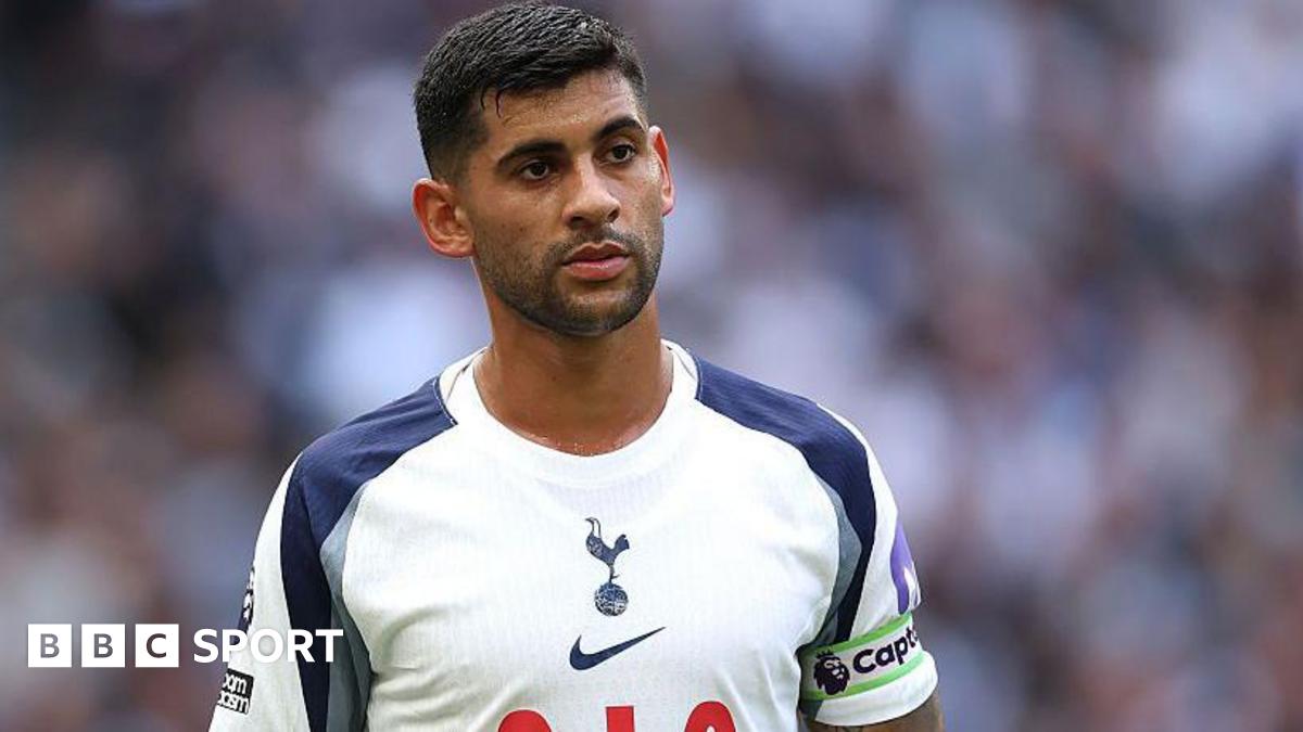 Cristian Romero wearing a white Tottenham matchday shirt