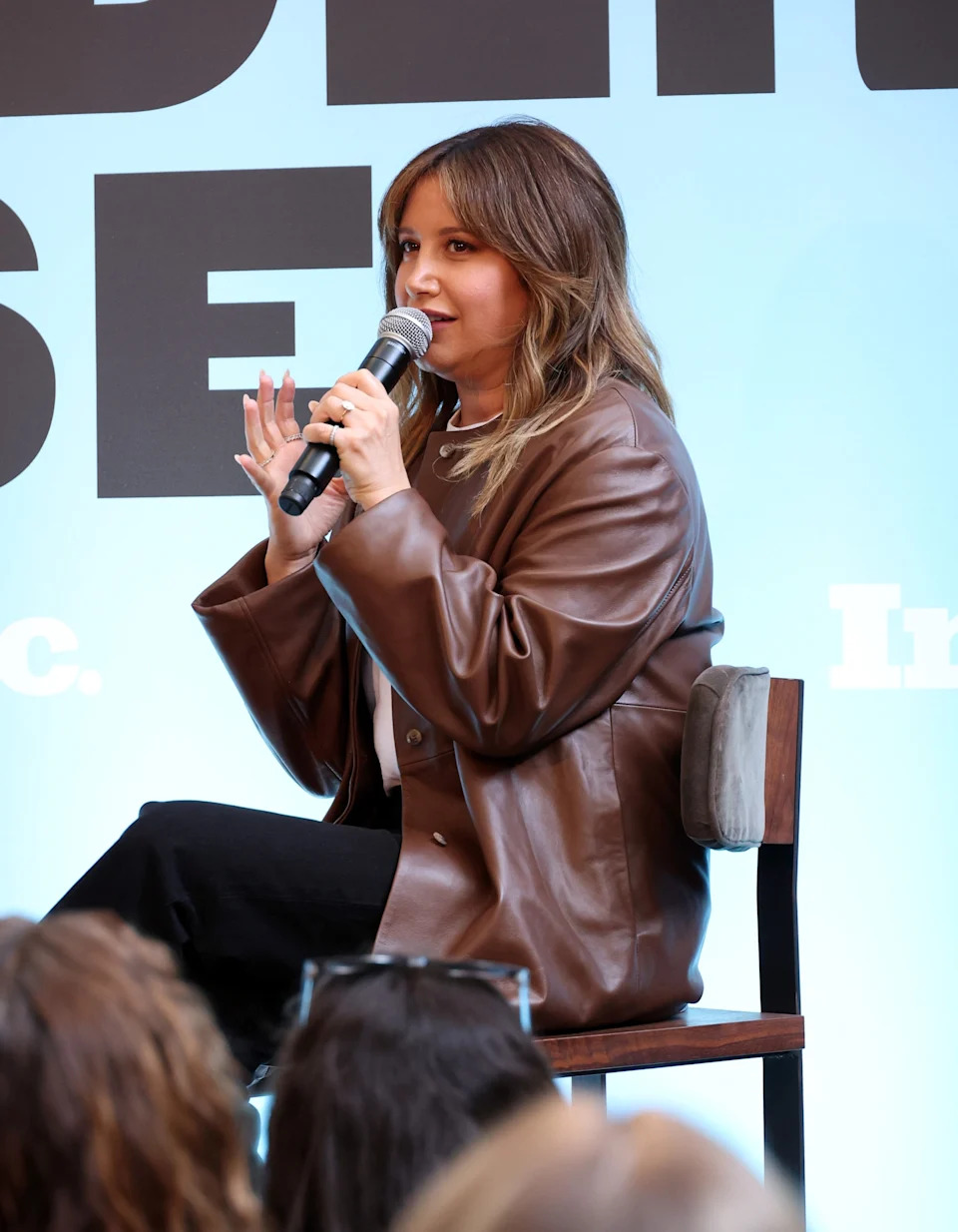 Ashley Tisdale speaking into a microphone