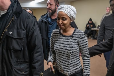 Ilhan Omar leaves a town hall after a man rushed the lectern and sprayed her with a strong-smelling liquid on Tuesday. Photograph: Victor J Blue/The New York Times
                      