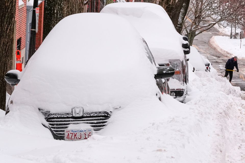 A man digs a car out of the snow on Beacon Hill following a winter storm that dumped more than a foot of snow across the region, Monday, Jan. 26, 2026, in Boston. (AP Photo/Charles Krupa)