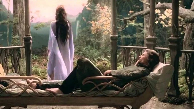 Arwen stands and Aragorn reclines on a patio in The Lord of the Rings movies
