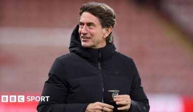 Spurs head coach Thomas Frank holds an Arsenal-branded cup before the loss at Bournemouth