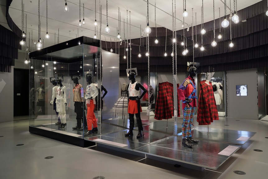 Exhibition shot of a number of punky mannequins in kilts and ripped t-shirts, lots of tartan