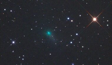Sungrazing comet: A blueish comet among a field of stars, including one reddish star.