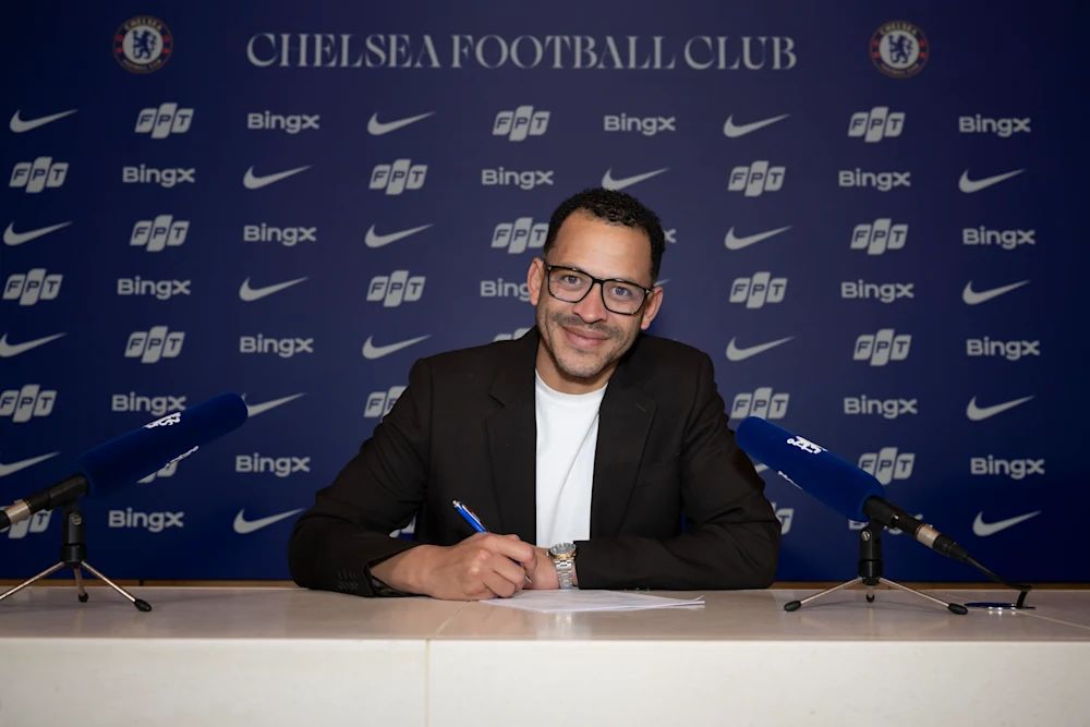 Liam Rosenior signs his Chelsea contract.