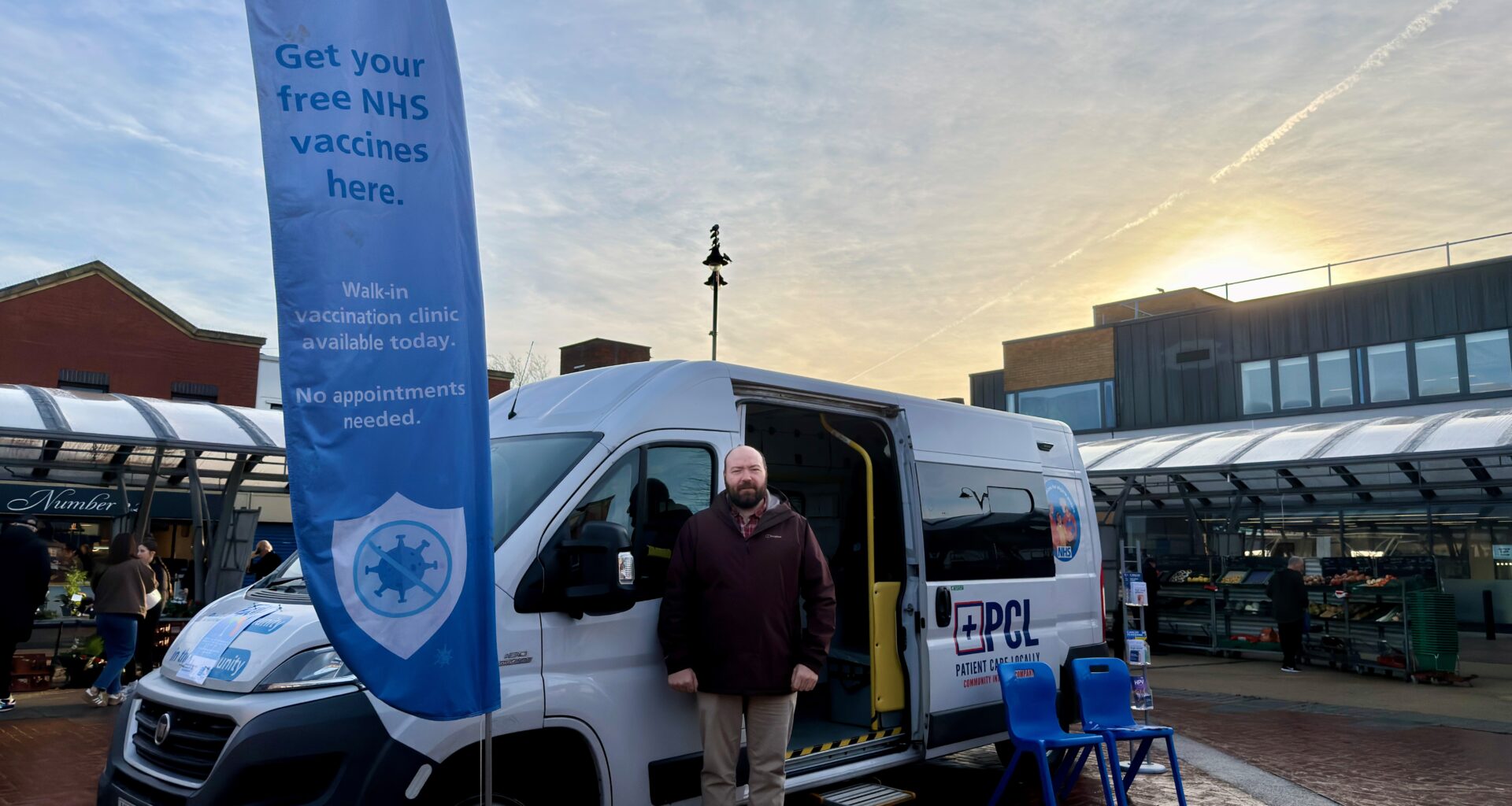 Image depicts Councillor Gary Flint standing outside a mobile vaccination van in Bloxwich.