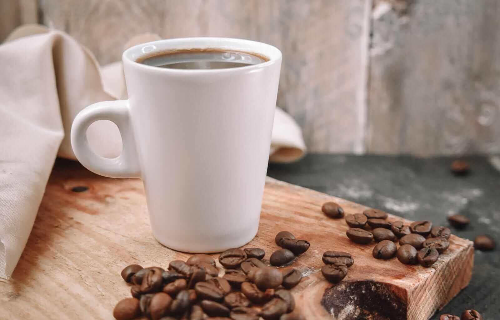 Cup of coffe with beans on the side by Carol La Rosa via Shutterstock