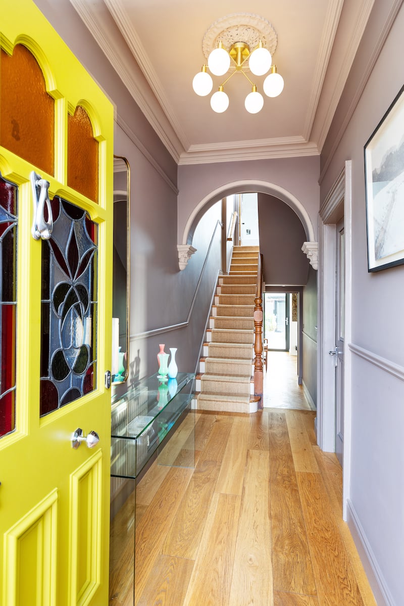 Entrance, showing the yellow front door with stained-glass panels