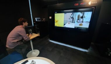 A dentist at ESA’s European Centre for Space Applications and Telecommunications (ECSAT) in the UK controlling a robotic arm at the University of Glasgow’s SCENE facility at Loch Lomond.