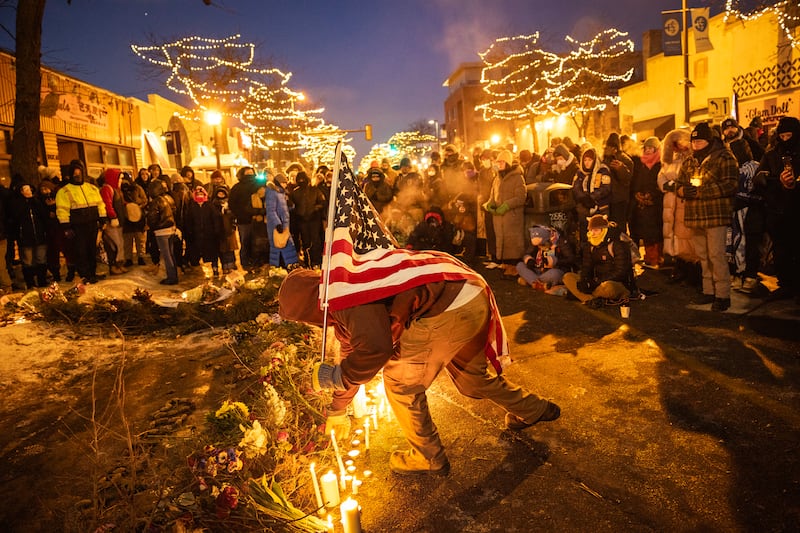 Demonstrators place candles and flowers at a makeshift memorial at the site where Alex Jeffrey Pretti was shot by Ice agents in Minneapolis. Photograph: David Guttenfelder/The New York Times