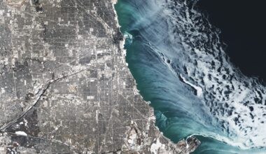 A satellite photo showing ethereal ice swirls along the shoreline of Chicago in Winter