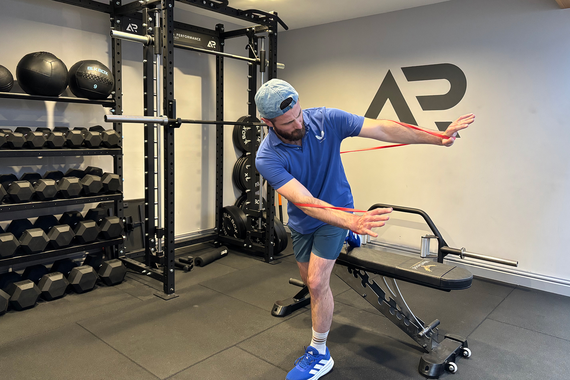 Baz Plummer demonstrating a single leg thoracic rotation with a band to increase tension and difficulty