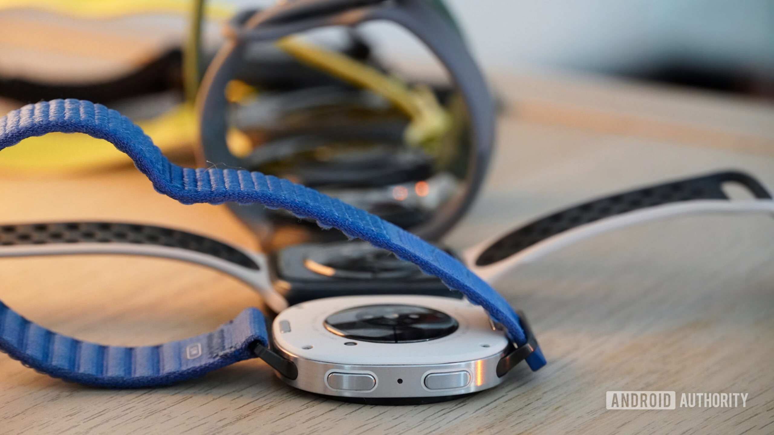 Galaxy Watch 8 AA 4 A collection of smartwatches showing the size of their sensors, with the Galaxy Watch 8 front.