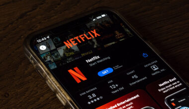 Netflix app is shown on a mobile phone.