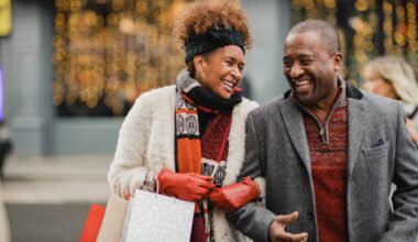 Senior couple crossing the road on a city street. They are walking with shopping bags while Christmas shopping.