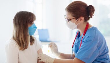 Doctor giving teen girl HPV immunization