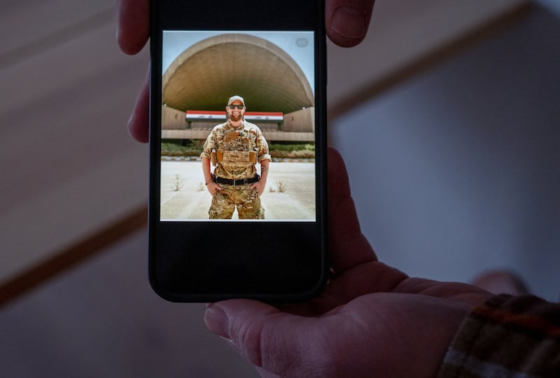 Henrik Bager, a Danish soldier who served as a Company Sgt Maj with US troops in Iraq and Afghanistan, shows a photo of himself in uniform, at home in Graested, Denmark. Photograph: Hilary Swift/The New York Times
                      