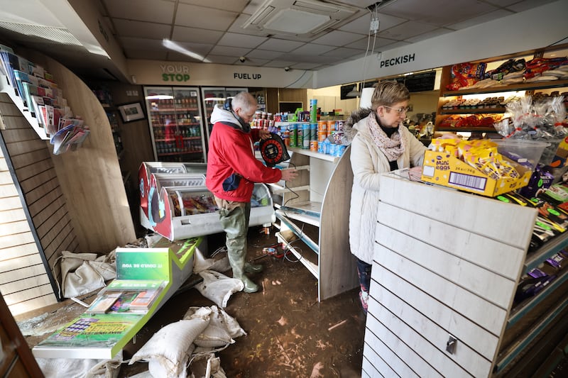 Ralph and Anne Swaine, of The Bus Stop Shop, cleaning up on Wednesday after Storm Chandra flood damage, along Shannon Quay, Enniscorthy, Co Wexford, beside the Slaney River which burst its banks.
Photograph: Dara Mac Dónaill / The Irish Times













