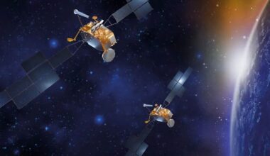 two satellites float in space orbiting Earth