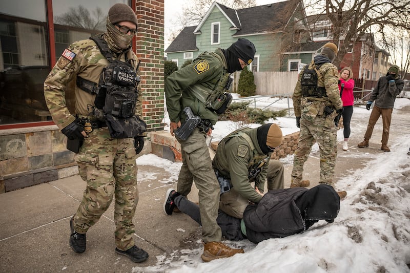 Federal agents detain a man after a foot chase in Minneapolis earlier this month. Photograph: David Guttenfelder/The New York Times
                      