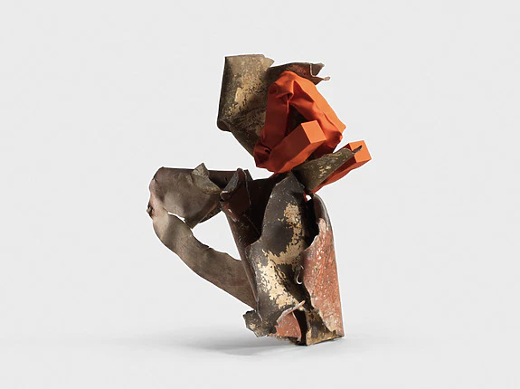 Abstract metal sculpture with twisted, rusted pieces and a vibrant orange section against a plain white background.