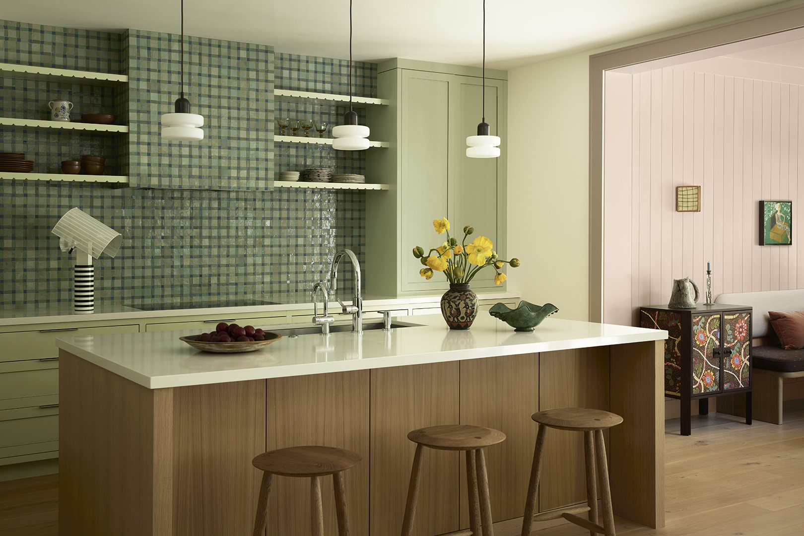 green kitchen with wood and marble island