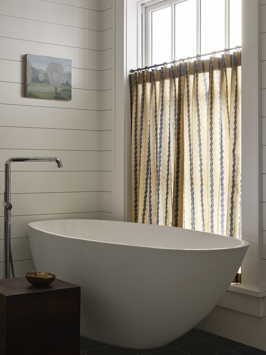 bathroom with freestanding tub and curtain