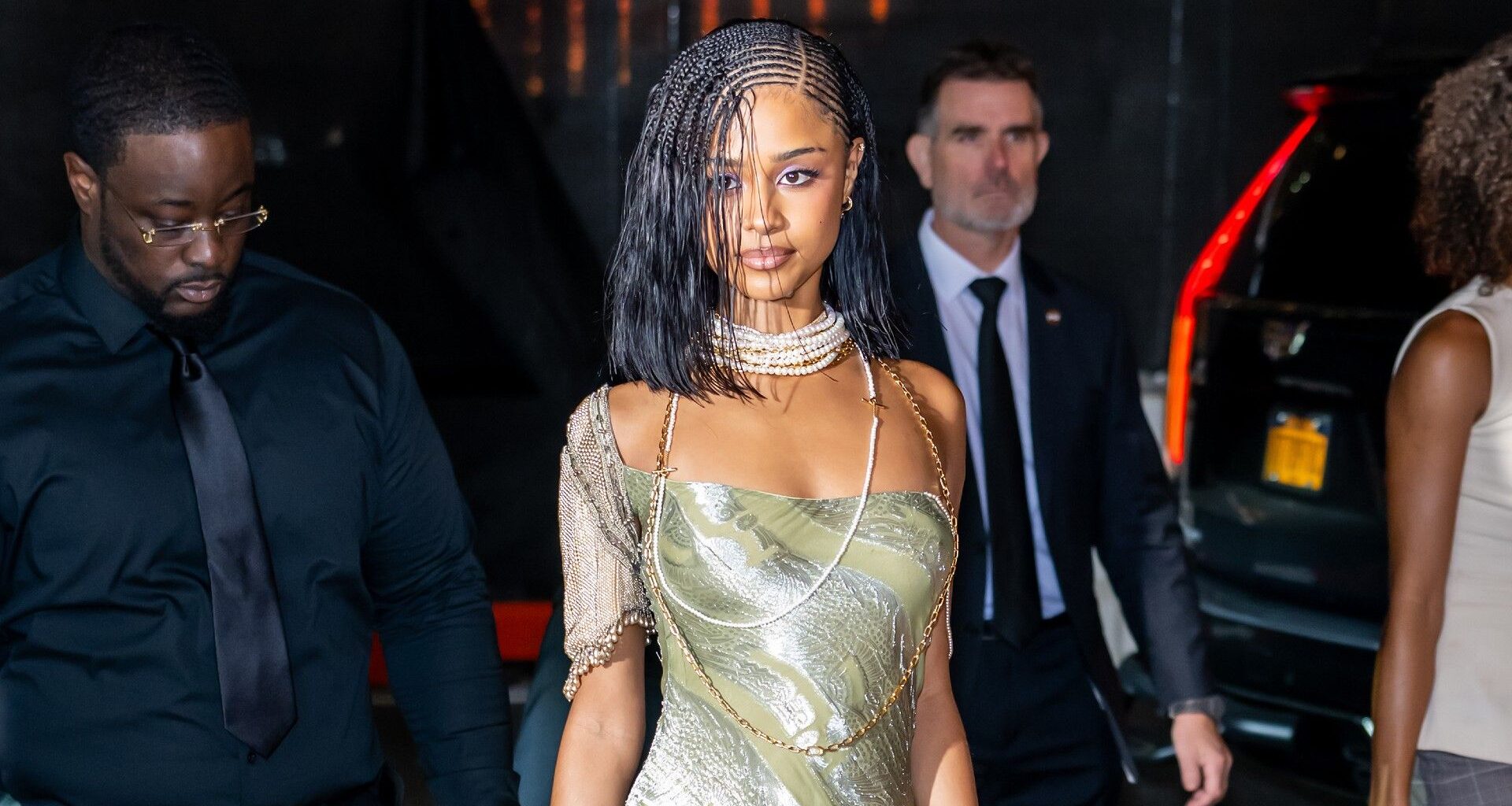 a black woman with braids photographed by paparazzi