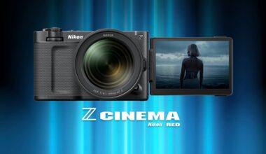 A Nikon camera with a large lens and a flip-out screen displaying a person standing by the sea, with “Z CINEMA Nikon RED” text below on a blue gradient background.