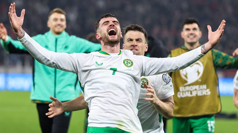 Ireland's Troy Parrott and Séamus Coleman celebrate after winning their World Cup qualifier against Hungary in Budapest on November 16th. Photograph: Stephen Gormley/Inpho