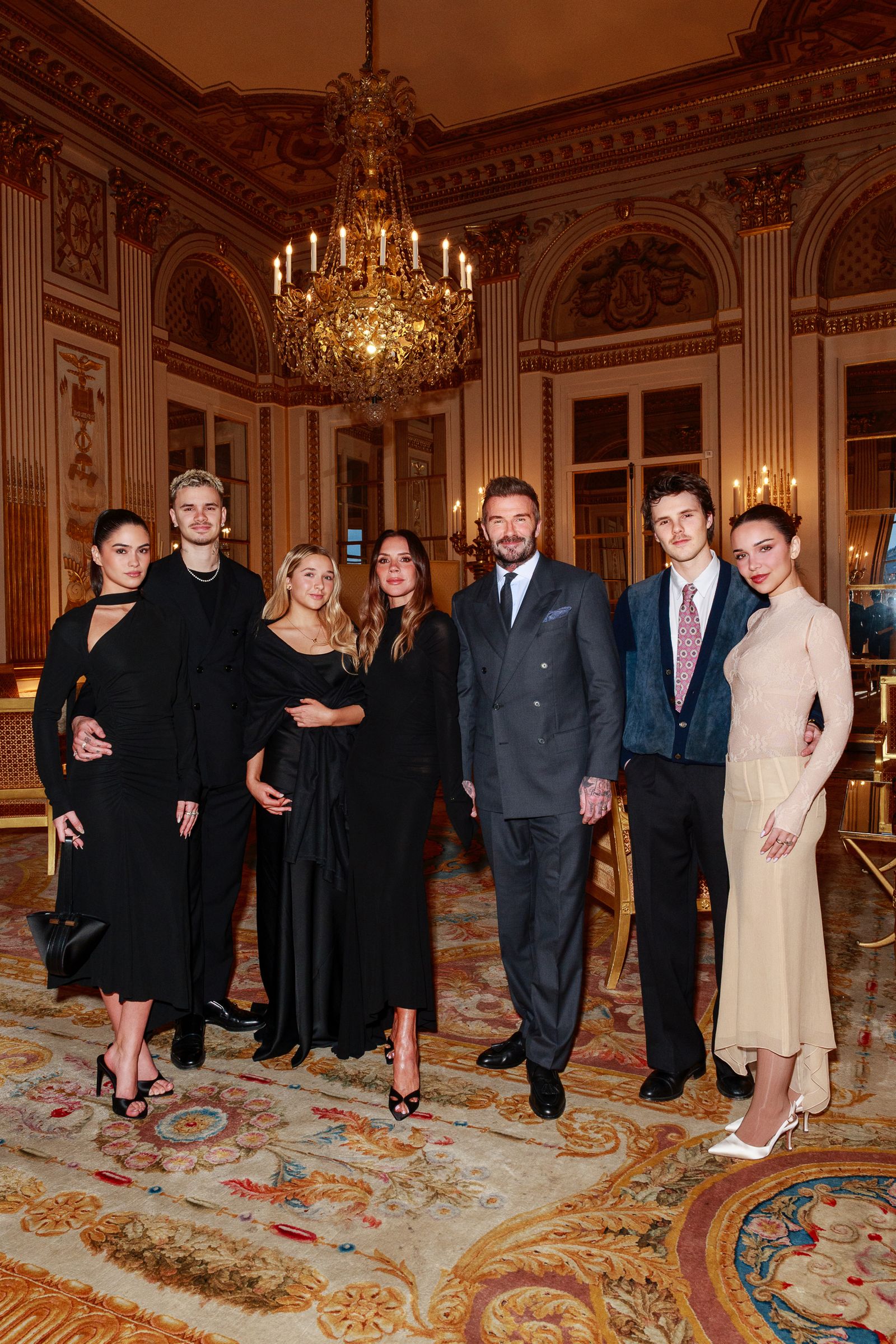 Image may contain David Beckham Victoria Beckham Chandelier Lamp Adult Person Groupshot People and Clothing