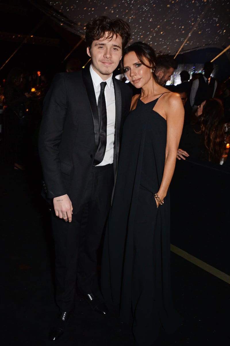 Brooklyn Beckham and Victoria Beckham attend The Fashion Awards 2018 in partnership with Swarovski at the Royal Albert Hall on December 10, 2018 in London, England.