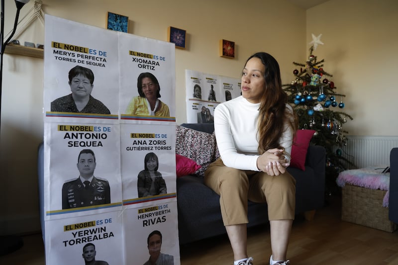 Carmen Parada Ortiz, a Venezuelan woman living in Ireland, with photographs of political prisoners in Venezuela, including her mother Xiomara Ortiz (in yellow). Photograph: Nick Bradshaw/The Irish Times

