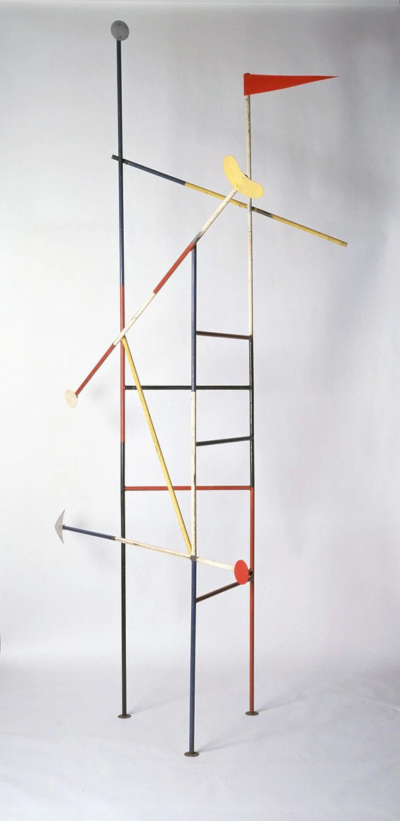 Abstract geometric sculpture with intersecting rods and shapes in red, yellow, and black on a plain white background.