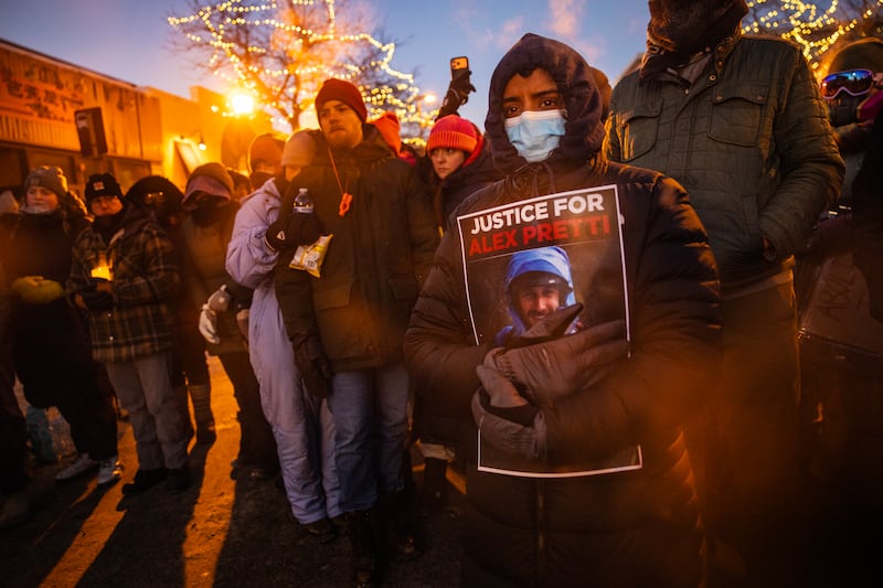 Demonstrators gather around a makeshift memorial at the site where Alex Pretti, a registered nurse was shot and killed in Minneapolis. Photograph: David Guttenfelder/The New York Times