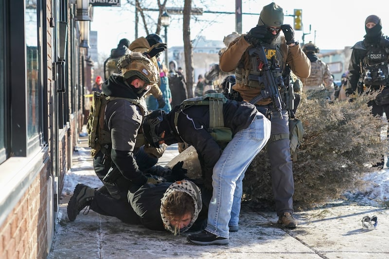 A protester is arrested as people gather after Ice agents shot and killed a man in Minneapolis on Saturday. Photograph: Craig Lassig/EPA