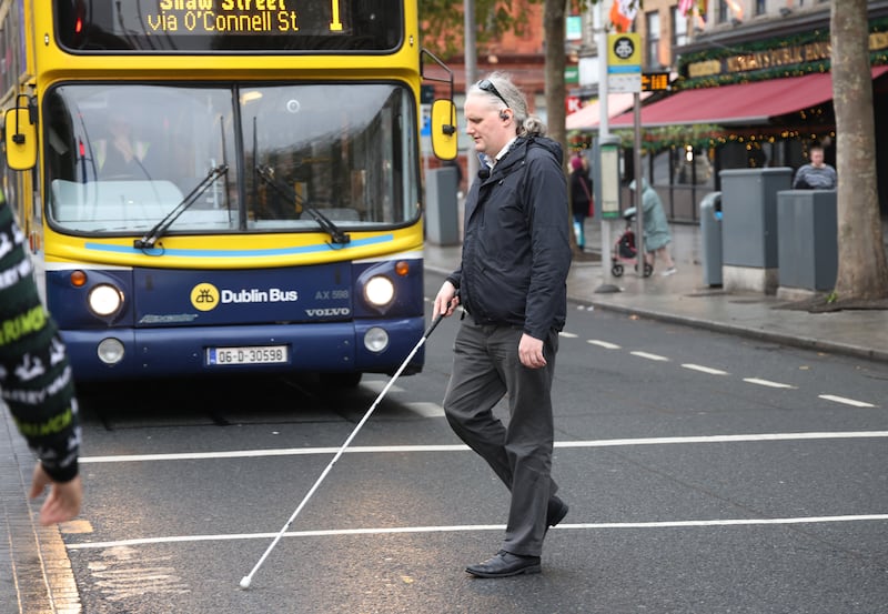 Declan Meenagh crossing Dublin's O'Connell Street. Photograph: Bryan O’Brien / The Irish Times
