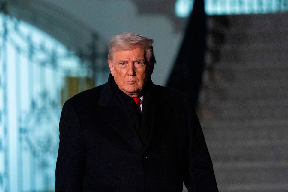 President Donald Trump speaks with reporters before departing on Marine One at the White House last night on his way to Davos. Photo: AP Photo/Alex Brandon