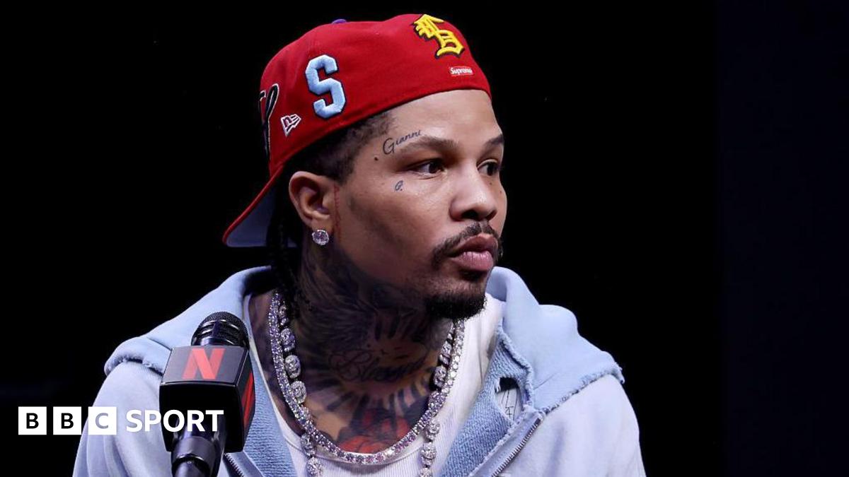 Gervonta Davis wearing a red baseball cap backwards with a grey hoodie