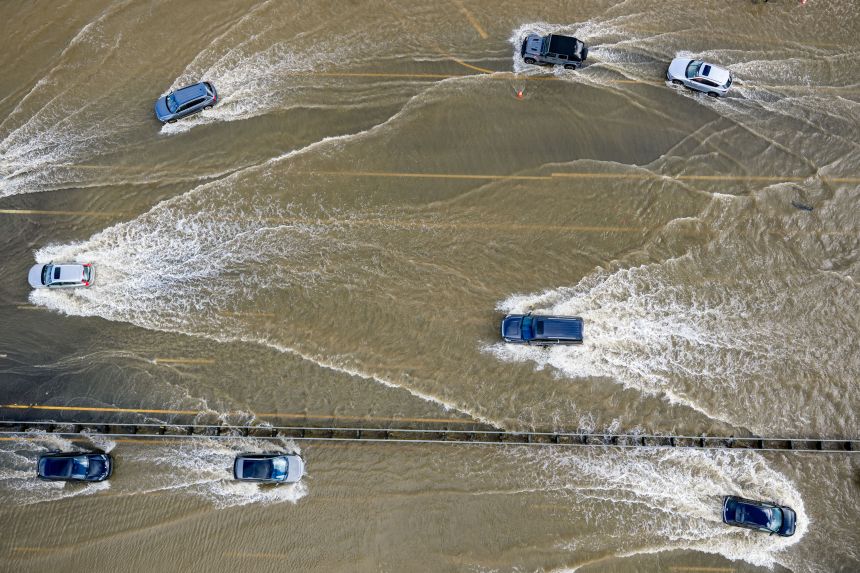 Cars drive on highway 101 flooded by the