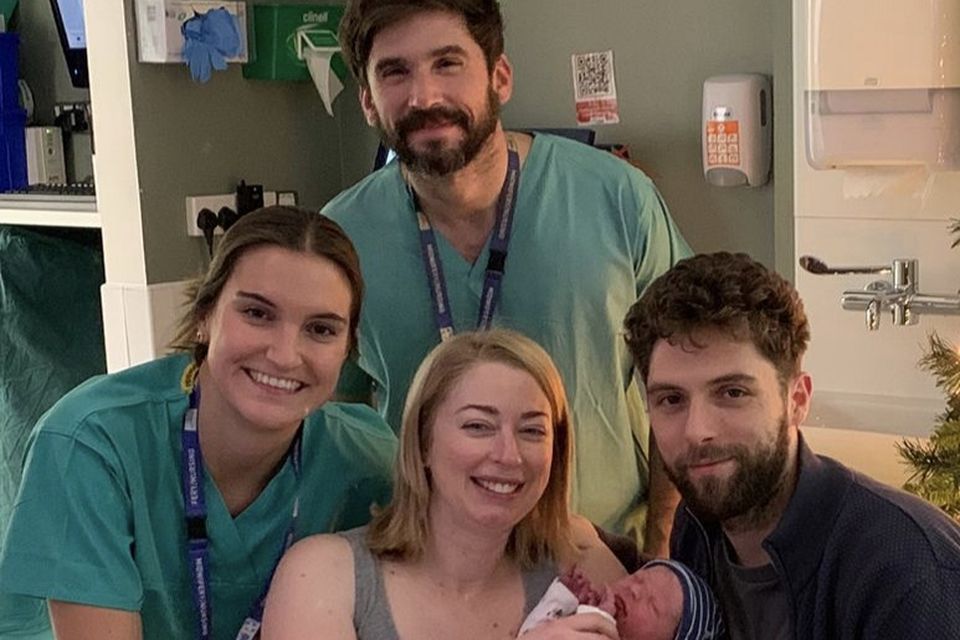 Baby Elliott, born at 35 seconds past midnight, weighing 3.66kg, with his parents Rachel and Adam Deak, from Rathnew, Co Wicklow. Also pictured, midwives Macarena and Nicolas at the Rotunda Hospital, Dublin.