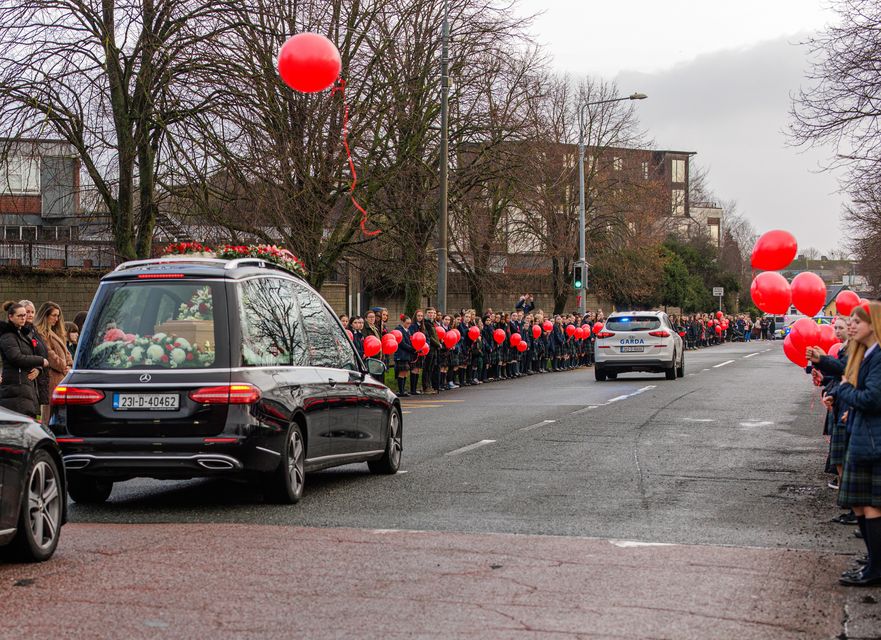 The funeral cortege of Grace Lynch passes St Michael's secondary school as students release ballons into the sky. Picture by Mark Condren