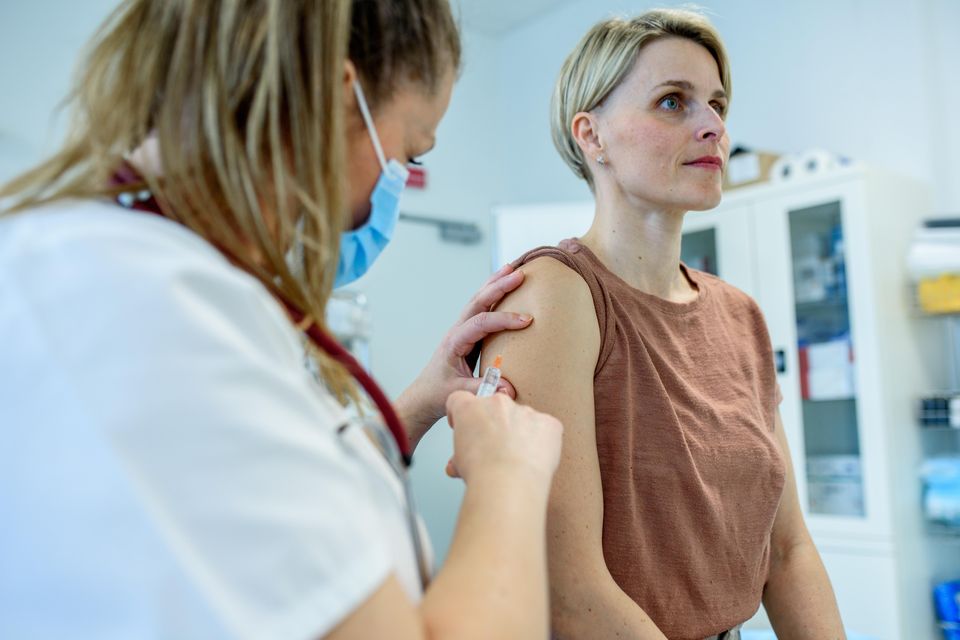 A medic administering a vaccine. Stock photo: Getty