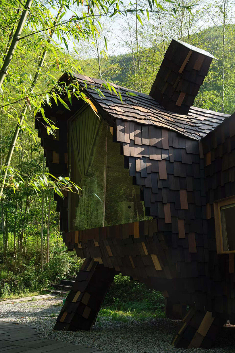 patchwork exterior of 'cat house' in china's anji forest is clad in discarded bamboo tiles