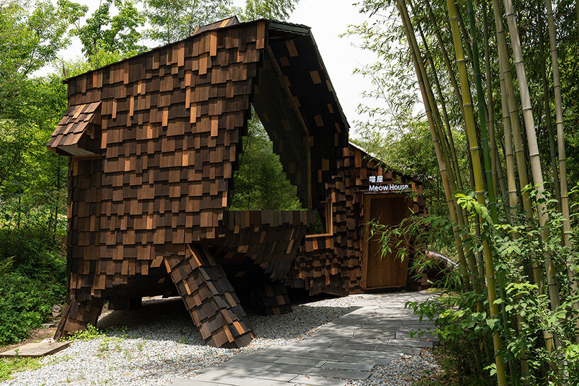 patchwork exterior of 'cat house' in china's anji forest is clad in discarded bamboo tiles