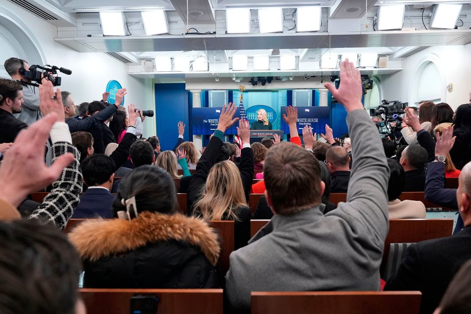 Reporters raise their hands to ask a question as White House press secretary Karoline Leavitt speaks in the press briefing room (AP Photo/Alex Brandon)