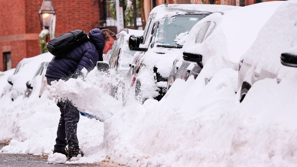 A man digs out his car on Beacon Hill following a winter storm that dump more than a foot of snow across the region, Monday, Jan. 26, 2026, in Boston. (AP Photo/Charles Krupa)